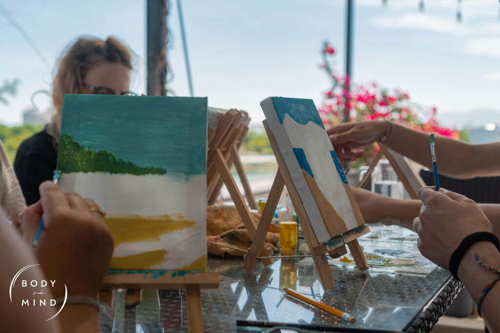 Guests are painting to release their inner artist, and improve their mental health at BodyVaMind - Surf Camp, Yoga, and Art Retreat in Vietnam.