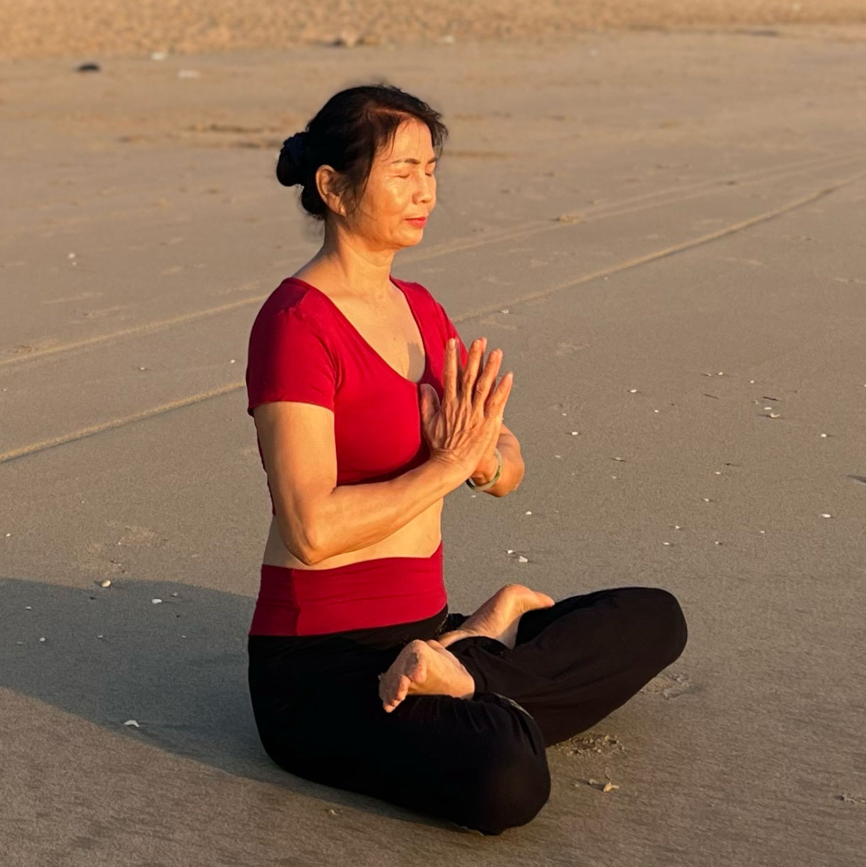 Senior Yoga Instructor BodyVaMind sunrise yoga at the beach